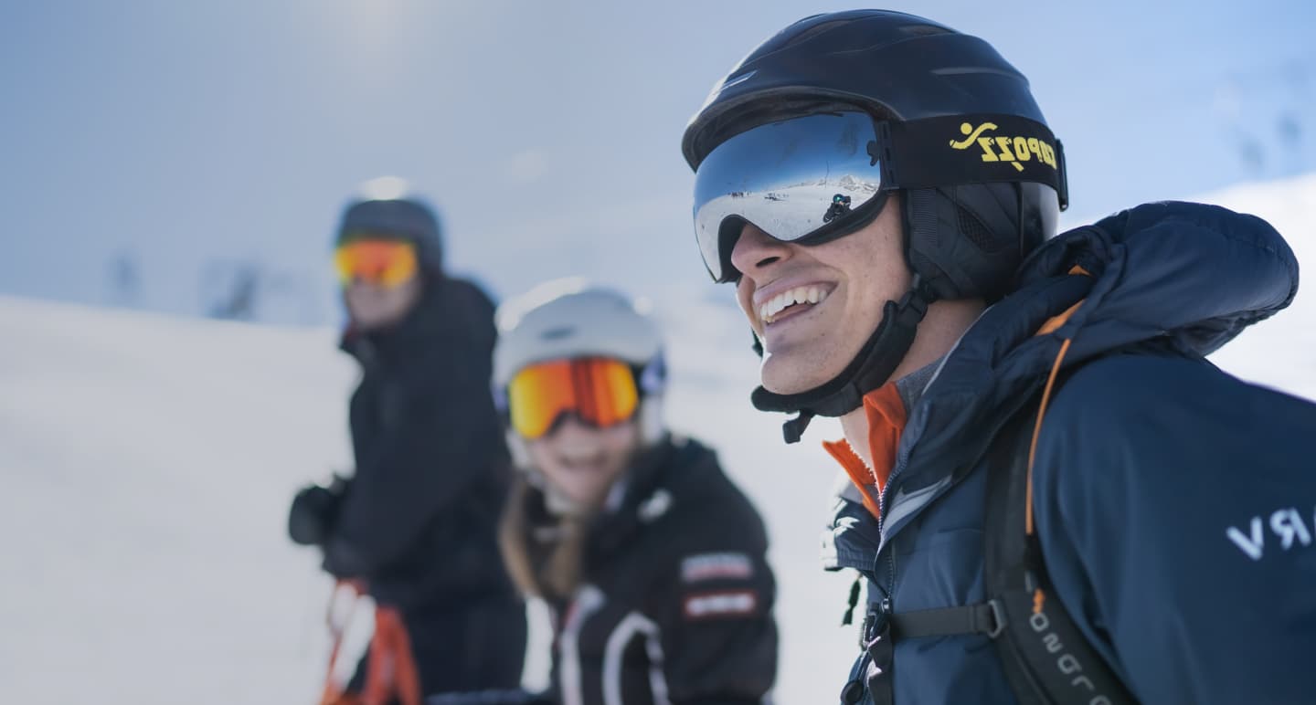 Background image showing a man on a ski slope